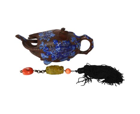 A Chinese terracotta teapot in the form of a gourd, with blue enamel painted decoration, L19cm, and a Chinese relief carved a