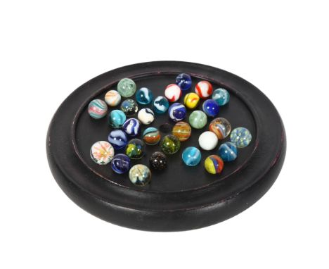 A painted wood Solitaire board with a set of Vintage marbles