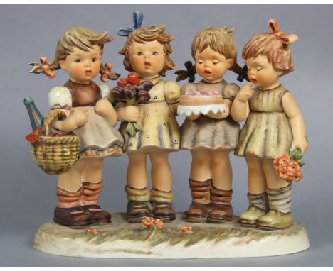 A Goebel Hummel figure group “We Wish You The Best” (No. 1989), 24cm wide x 21cm high.