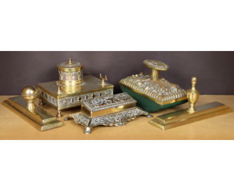 A 19th century-style brass-embossed ink-blotter; two brass paper weights; a brass inkwell; &amp; a brass embossed stamp box. 