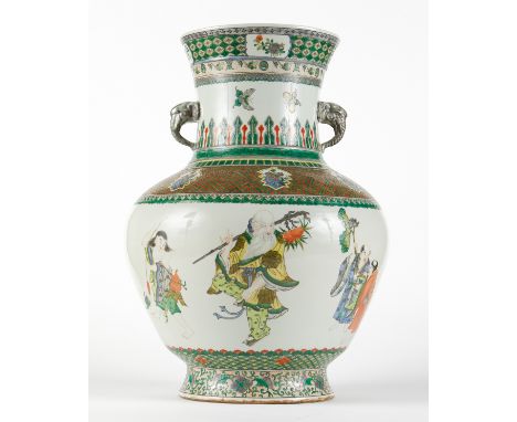 Enormous Chinese famille verte porcelain vase. Of baluster form with two handles in the form of elephant heads. Decorated alo