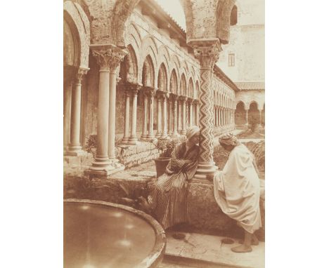 Wilhelm Von Gloeden (German, 1856-1931). Photograph titled "The Monreale Cloister," depicting two figures in conversation, on