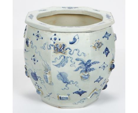 Chinese porcelain planter or jardiniere, in an octagonal form. Decorated along the exterior with blue and white scholar's obj