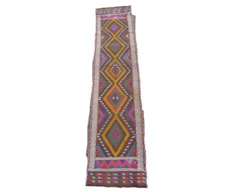 An old Suzni Kilim runner, with five central, caucasian, orange, purple and blue bands of colour, 244 by 56cm. 