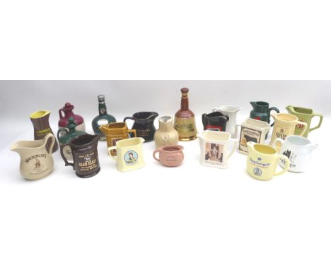 A collection of twenty-one ceramic advertising whisky, gin and rum jugs and decanters. (21) 