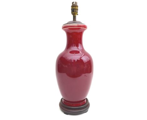 A Chinese porcelain table lamp, sang de boeuf glaze, 50cm overall.In need of re-wiring.