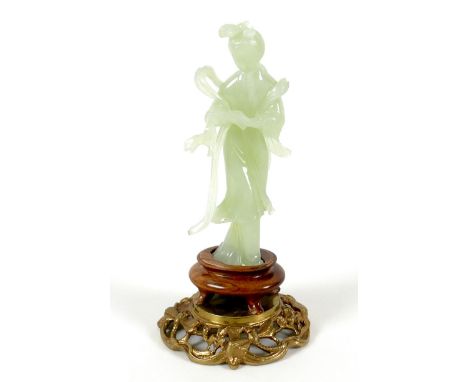 A Chinese carved jade figure, late 20th century, modelled as a lady in standing pose, on a turned wooden socle and gilt metal