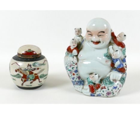 A Chinese porcelain figure, modelled as a Buddha with five children, decorated in famille rose palette, impressed seal mark t