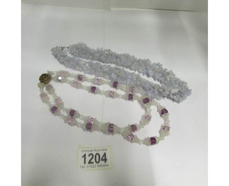 A Victorian necklace of an unusual shape in an amethyst coloured glass and a blue agate necklace
