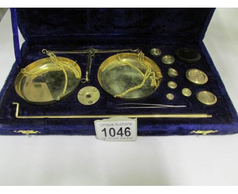 A cased set of precious metal weighing scales