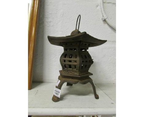 An ornamental cast iron candle lamp