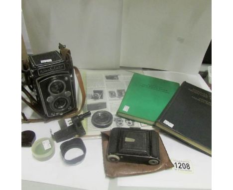 A Rollieflex camera with Rollie book by Dr. Heering, magazine artical, Zeiss Ikon Derval camera with manual of the miniature 