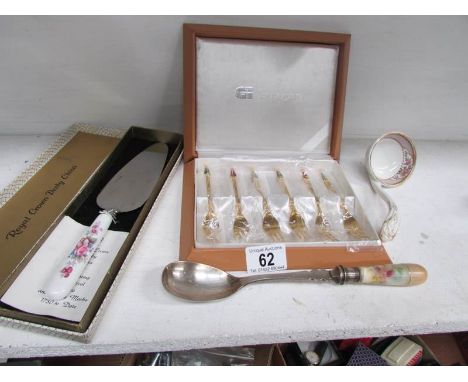 A cased set of dessert forks, a cake slice, ladle and one other item