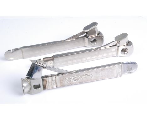 An early 20th century continental steel and white metal cigar cutter, the lever with applied flower head decoration and the w