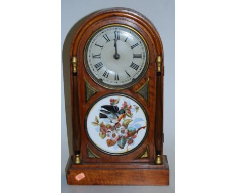 A late 19th century continental walnut cased dome top mantel clock, having a silvered dial with Roman numerals enclosed by a 