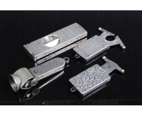 A late Victorian silver pocket cigar cutter of rectangular form having all over foliate engraved decoration and retracting sc