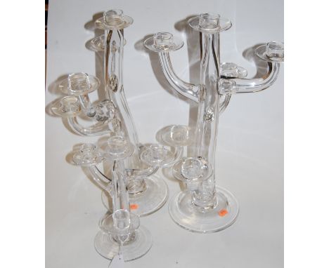 A pair of contemporary Cleyberg clear glass five-sconce table candelabra, h.50cm; together with a single four-sconce candelab