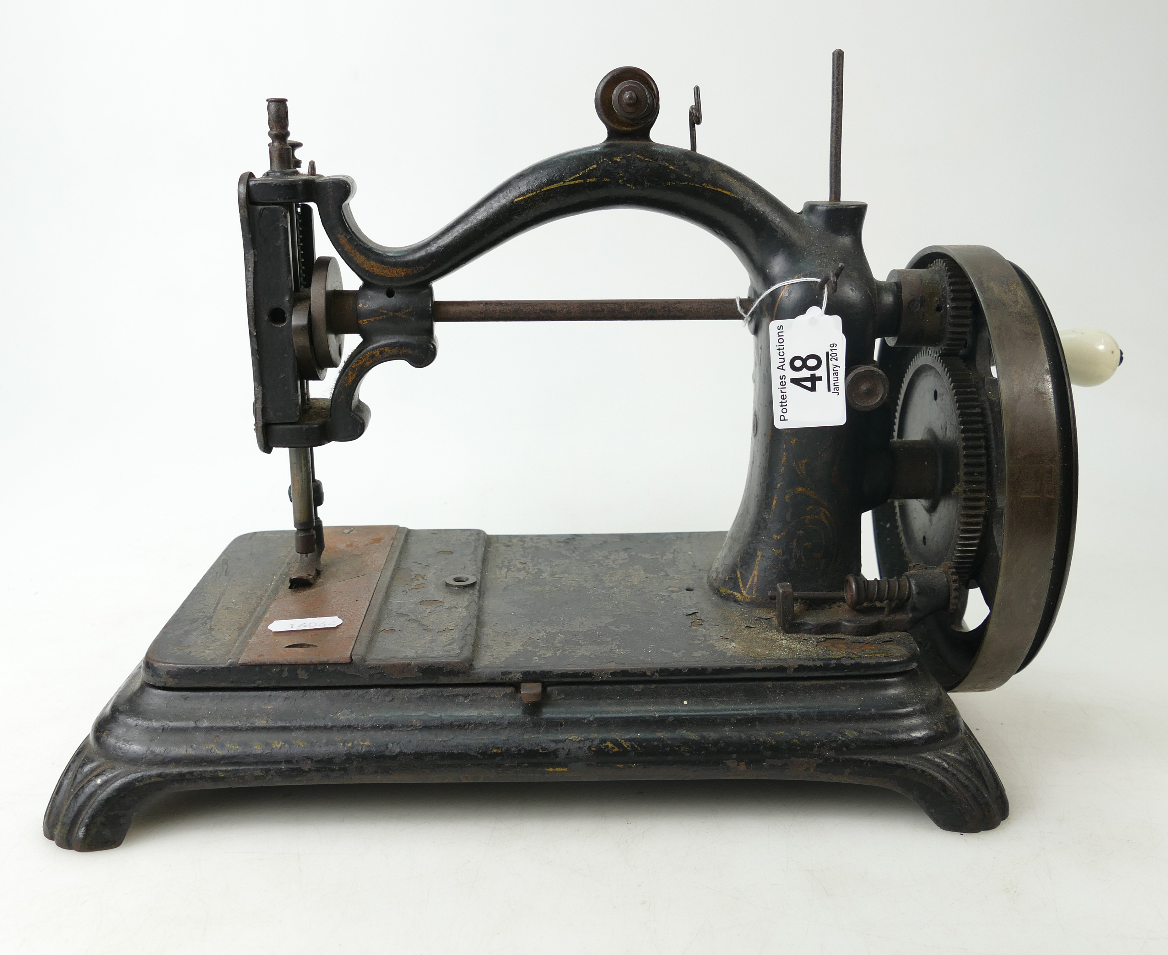 Cast iron sewing machine with arch top, mid to later 19th century.