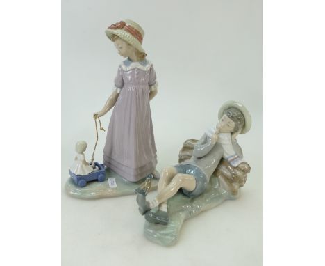 Lladro figure of girl with doll in toy cart similar figure of reclining boy(2)