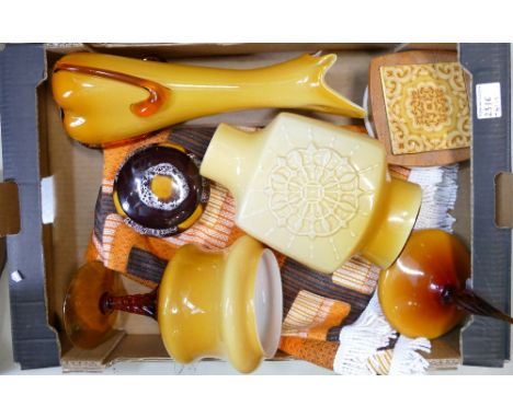 A collection of 1970s retro glass and ceramic items and a similar table cloth.