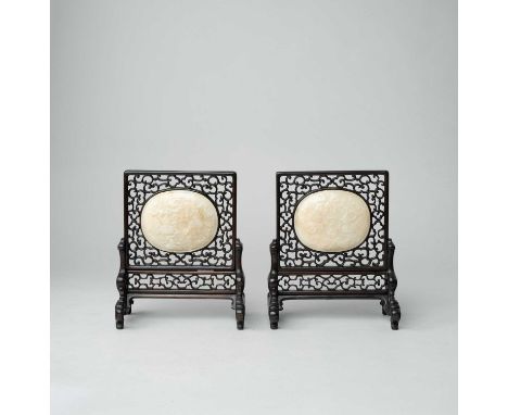 A PAIR OF SMALL CREAMY-WHITE JADE AND ZITAN TABLE SCREENS18TH CENTURYThe oval jade plaques carved with three gourds amidst tr