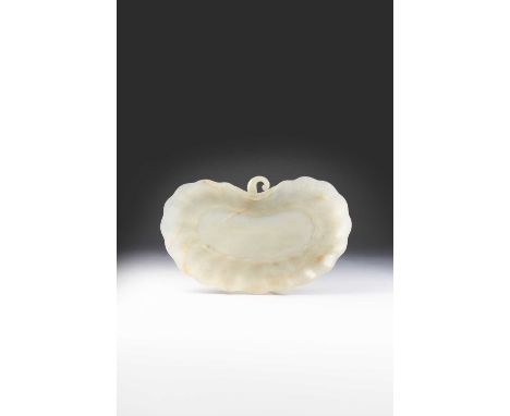 A MUGHAL CELADON JADE 'LEAF' DISH17TH/18TH CENTURYThe thinly carved dish of kidney shape, with a curved stem, the shallow sid