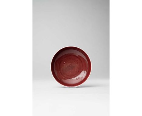 A CHINESE COPPER RED-GLAZED DISHKANGXI 1662-1722With shallow rounded sides, the interior and exterior covered with a soft cru