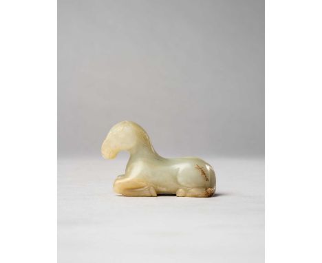 A CHINESE CELADON JADE CARVING OF A HORSEQING DYNASTYThe recumbent animal facing forward with its legs neatly tucked under th