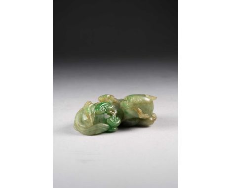 A CHINESE JADEITE CARVING OF A MYTHICAL BEASTQING DYNASTYThe recumbent horned creature with its head turned back and a sprig 