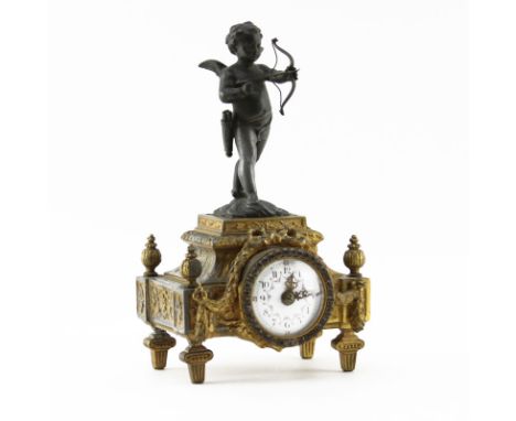 Early 20th Century French White Metal Clock with Cherub Finial. Depicts a white metal cherub figurine mounted to a gilt white