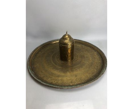 Large circular Eastern brass tray, approx 58cm in diameter, with a brass tea caddy depicting peacocks and men on various anim