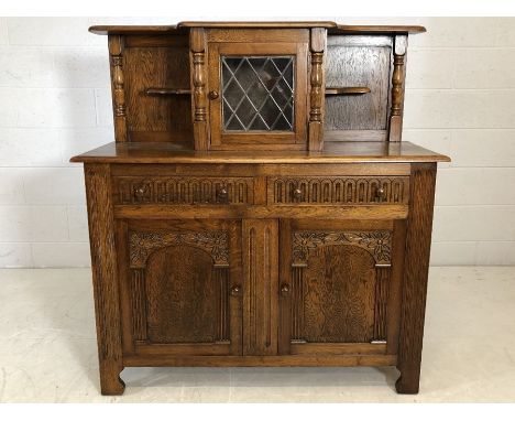 Sideboard / buffet with cupboard and two drawers under and central cupboard over with glazed door by Shepherd and Hedger of D