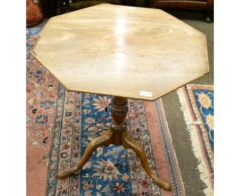 A George III mahogany tripod table with octagonal tilt top Chips and losses to the top, very faded. Some scuffs and light scr