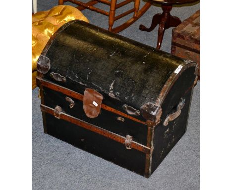 A dome toped trunk, with leather carrying handles 