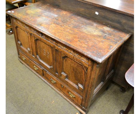 A 19th century oak coffer, fitted with two base drawers, the central panel engraved with the initials 'W B R' 