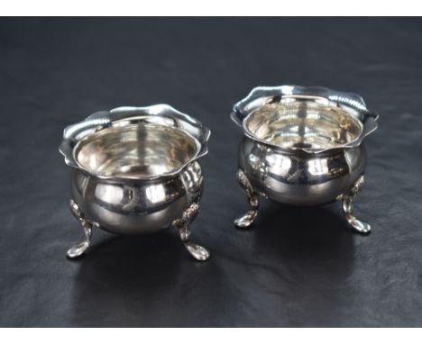 A pair of Edwardian silver salts, of bulbous form having Chippendale style rim, raised on three cabriole style legs, marks fo