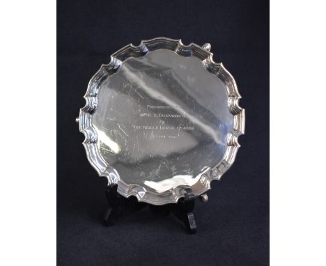 A George VI silver salver, of circular form having a Chippendale style rim, with a central personalised engraving 'Presented 