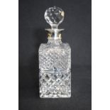 An Elizabeth II silver mounted cut glass decanter, of rectangular form having a silver mount and