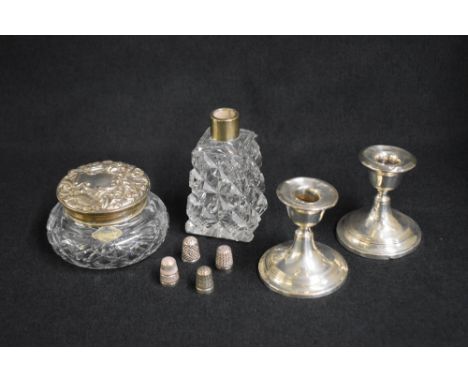 A pair of late Edwardian silver candlesticks, of traditional form having step moulding decoration, marks for Birmingham 1910,