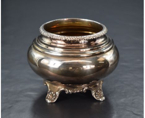 A Victorian silver sugar bowl, of a bulbous form having a decorative moulded rim and step moulded to the body, raised on four