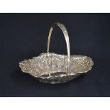 A late Victorian silver fruit bowl, of oval form having a handle with thread and embossed foliage
