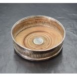A Georgian silver wine coaster, of circular form having a gadrooned style rim, half gadrooned