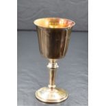 A cased Elizabeth II silver cup, of traditional form having a slightly flared rim, gilted interior
