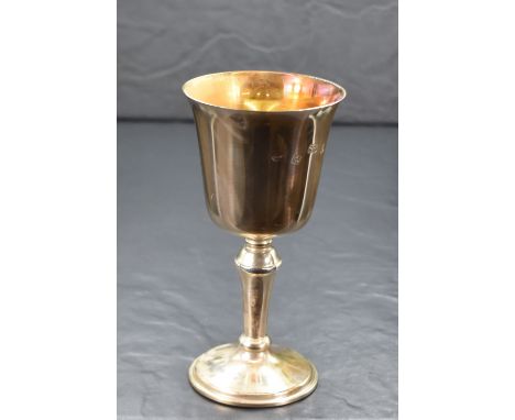 A cased Elizabeth II silver cup, of traditional form having a slightly flared rim, gilted interior raised on a knopped stem a