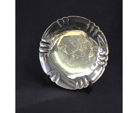 A George VI silver salver, of circular form having a lobed rim raised on a circular step moulded foot, marks for London 1945,