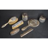 A George V silver mounted vanity set, comprising a hair brush, a clothes brush, comb, a mirror,