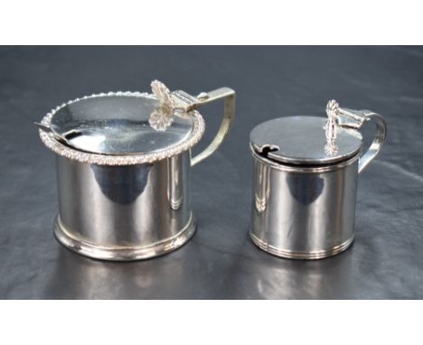 An Edwardian silver mustard, having a gadrooned rim and step moulded base with condiment spoon and blue glass liner, marks fo