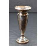 An Elizabeth II silver fluted vase, having a slightly flared rim with moulded decoration, raised
