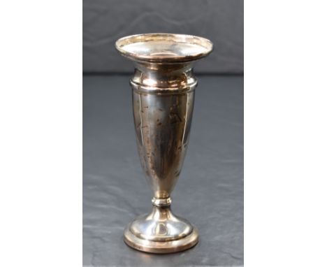 An Elizabeth II silver fluted vase, having a slightly flared rim with moulded decoration, raised on a small knopped stem and 