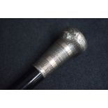 A George V silver mounted walking stick, the pommel having engine turned decoration to the